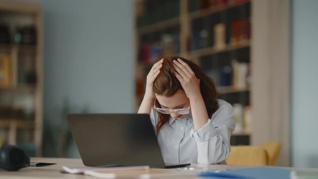 Stressed woman experiencing headache at work