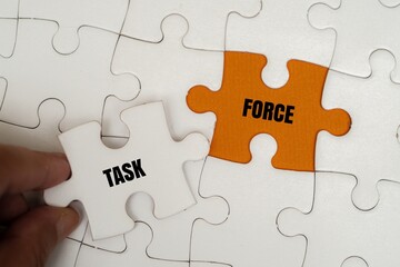 Fototapeta premium TASK FORCE word alphabet letters on puzzle. Concept of professional collaboration, problem-solving and team mobilization