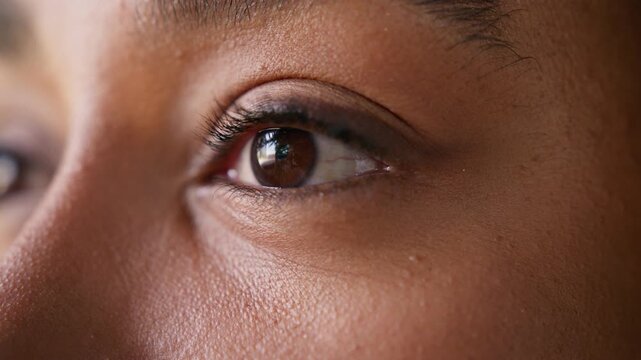 Close up African American business woman dark eyes blinking looking distance in city outdoors female businesswoman makeup long eyelashes healthy vision eyesight laser correction medicine eye care gaze