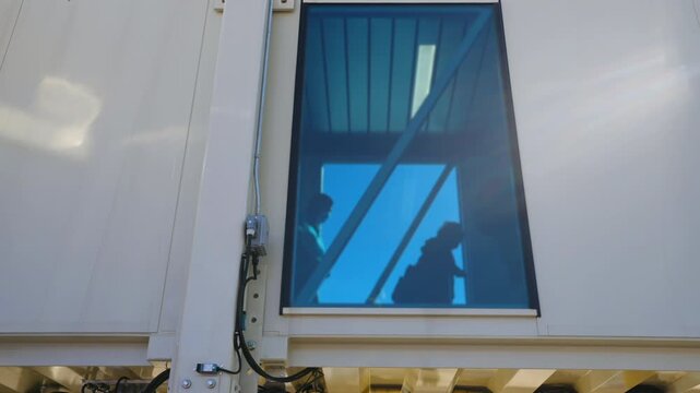Commercial Airliner At Gate With Jet Bridge And Ground Crew Preparing For Boarding And Luggage