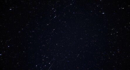 Fototapeta premium Glowing space stones streaking rapidly in a dark sky dome