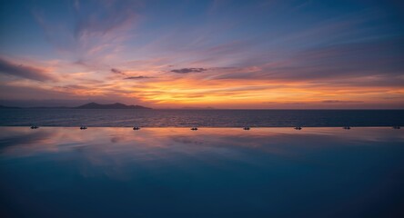 Obraz premium peaceful pool in front of a vibrant sky horizon
