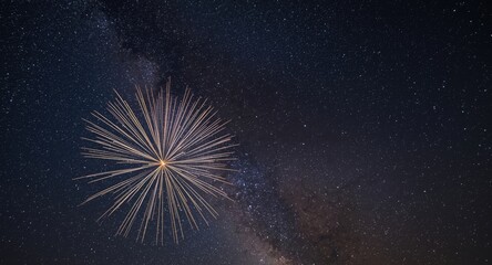 Fototapeta premium Night fireworks illuminating the cosmic scene of the Milky Way in the sky