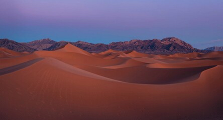 Fototapeta premium Limitless desert hills glowing warmly in evening near gentle mountain contours