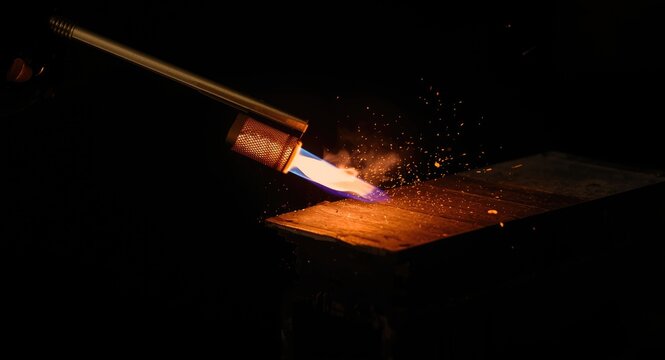 Flame torch close look at material undergoing rigorous fire safety testing