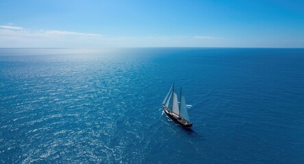 Obraz premium Sailing ship observed from drone aerial shot over vast ocean