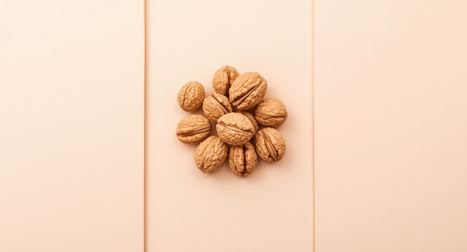 Isolated whole walnuts on a calm pastel panel background highlighting copy space