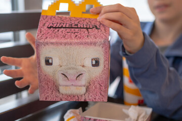 Naklejka premium complete Happy Meal experience, Minecraft Happy Meal box, fast food for kids, cartoon character packaging, Frankfurt - April 21, 2025