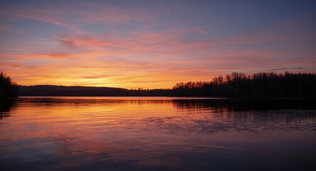Fototapeta premium Peaceful lake scene under a stunning sunset sky background
