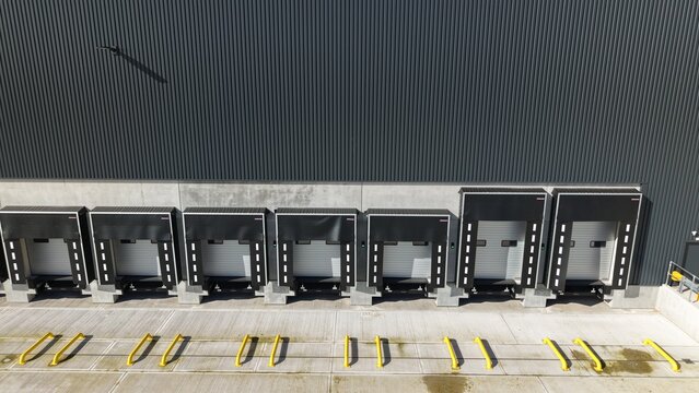 Aerial view of loading docks casting shadows against the corrugated facade, creating an industrial rhythm of light and dark, Doncaster, United Kingdom.