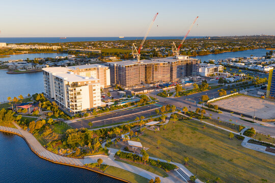 Aerial view of  tall cranes on a construction site on top of highrise buildings