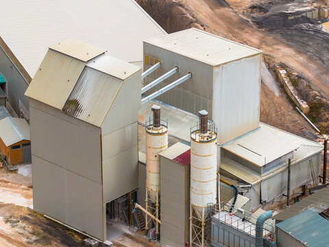 Aerial view of the industrial structures casting shadows on the terrain, a symphony of geometric forms and utilitarian design, Magliano de' Marsi, Abruzzo, Italy.
