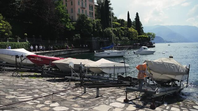 Calm and peaceful boats on the lake shore on a sunny warm day. High quality 4k footage