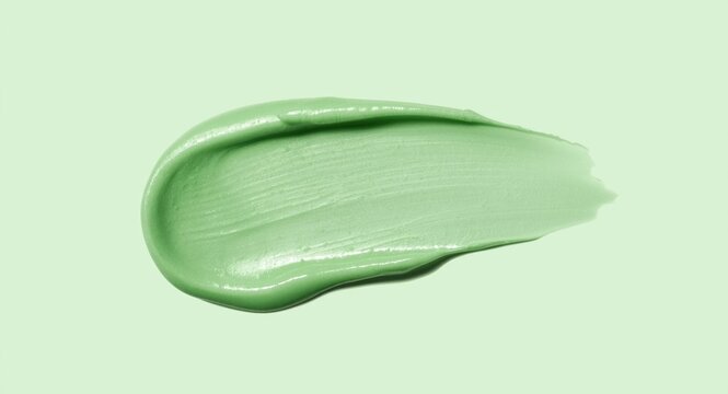 Isolated green cosmetic cream smear with creamy texture on plain background