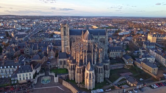 Approaching panorama drone shot of the iconic Le Mans Cathedral aka Cathedral of Saint Julian with Le Mans skyline at sunset, France
