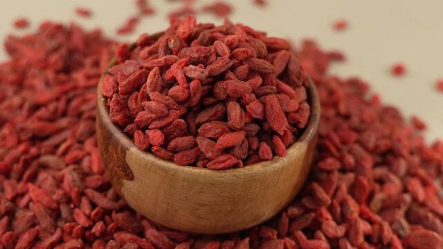 Dried Goji berries or Wolfberry on a wooden bowl panning shot.