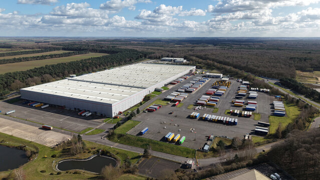 Aerial view of a vast distribution center, trailers lined up in organized rows contrasting against the sprawling landscape, Worksop, England, United Kingdom.