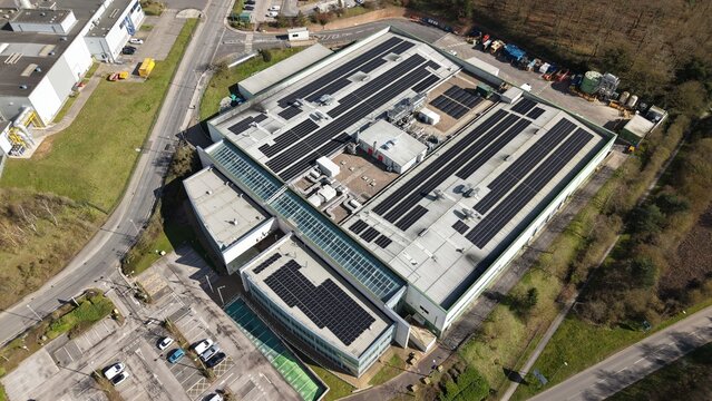 Aerial view of the building adorned with solar panels, reflecting the commitment to renewable energy, contrasting with the surrounding verdant landscape, Worksop, England, United Kingdom.