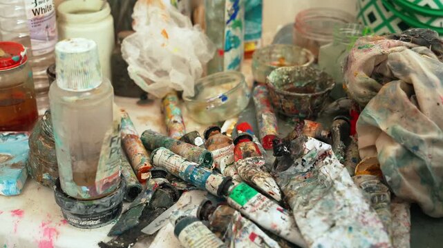 Static shot of paints, dyes, spirits and other painting items.