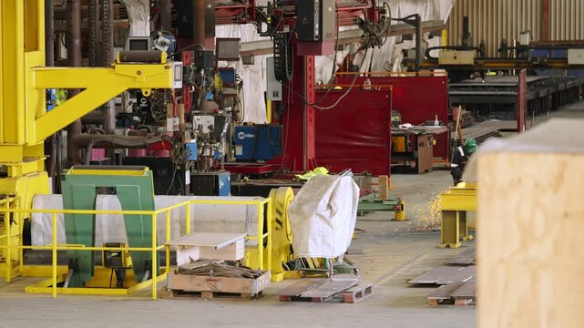 Static shot inside a metal fabrication, welding and manufacturing factory.