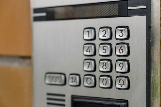 Close-up of intercom system with numeric keypad and speaker grill