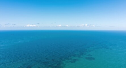 Fototapeta premium Expansive ocean view with bright blue skies and gentle breeze