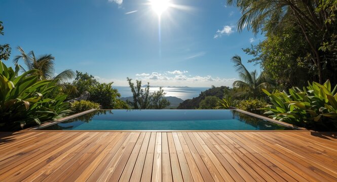 Peaceful wooden deck overlooking luxury pool bordered by lush plants beneath bright sky