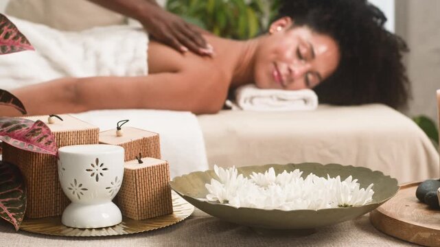 Peaceful Spa Day: Black Woman Enjoys a Relaxing Back Massage in a Serene Setting
