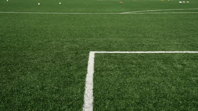 White penalty area markings on the artificial turf of a soccer field.