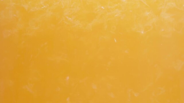 Orange juice with pulp, macro textures in a glass.