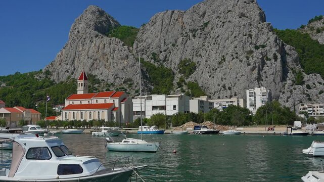Historic town Omis at the foot of massive cliffs by the river.