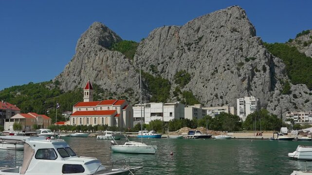Historic town Omis at the foot of massive cliffs by the river.