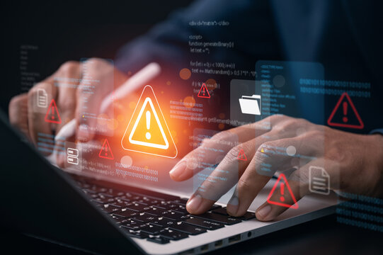 Cybersecurity threat warning concept with developer analyzing system code on laptop while digital alert icon highlights network security risk data breach detection and cyberattack protection.