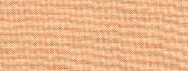 Fototapeta premium Texture light peach textile material background, macro weave pattern. Structure of pastel coral fabric backdrop