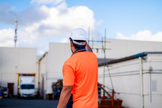 Samoan man in high vis clothing giving hand signals