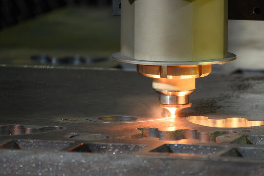 High-power fiber laser cutting machine processing a thick metal plate with extreme precision in an industrial fabrication facility.