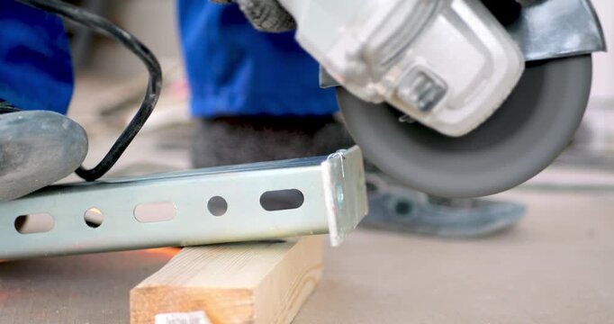 Worker Cutting Metal Bracket Angle Grinder Abrasive Disc Sparks Flying Industrial Process Construction Work Tool Operation Metalworking Manufacturing Workshop Safety Equipment