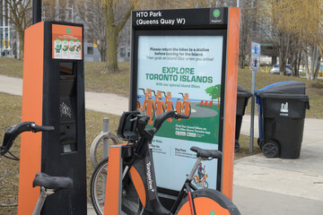 Naklejka premium Bike Share Toronto kiosk poster and bike rental unit at HTO Park and Queens Quay W