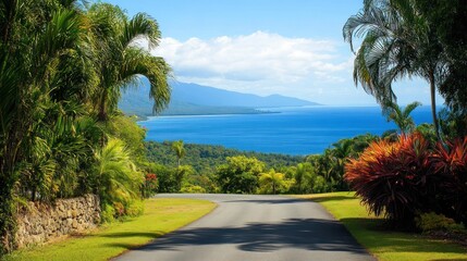 Fototapeta premium Tropical Coastal Road with Lush Greenery and Breathtaking Ocean View in Daylight under Clear Blue Sky