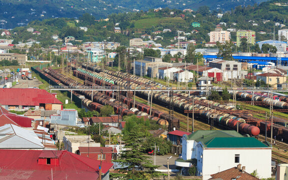 Railway yard in Batumi, Georgia handling freight operations with long lines of oil tank cars on parallel tracks. Scene illustrates transport logistics trade flows supply chains and energy distribution