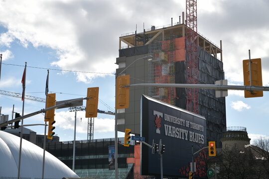 Varsity Blues sign at Varsity Stadium and construction of The Academic Wood Tower (110 Devonshire Place), Toronto