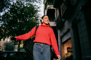 Pensive female professional looking away while holding digital tablet and stylus in cafe,...