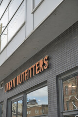 Naklejka premium exterior building facade and sign of Urban Outfitters, a clothing store chain, located here at 481 Queen St W, Toronto