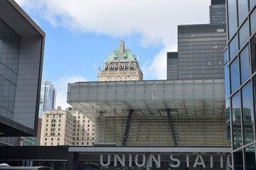 Naklejka premium Union Station sign entrance from Maple Leaf Square (Bremner Blvd) with view of Fairmont Royal York hotel, and building in Toronto Financial District