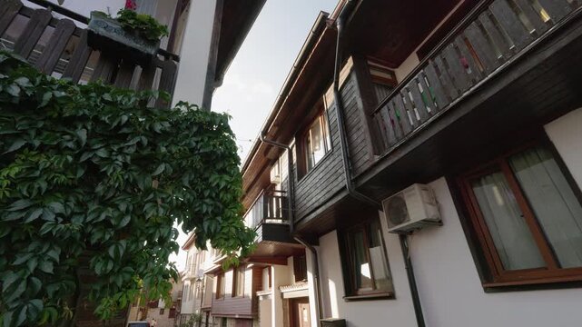 Traditional wooden houses with balconies and green ivy in old Nessebar Bulgaria