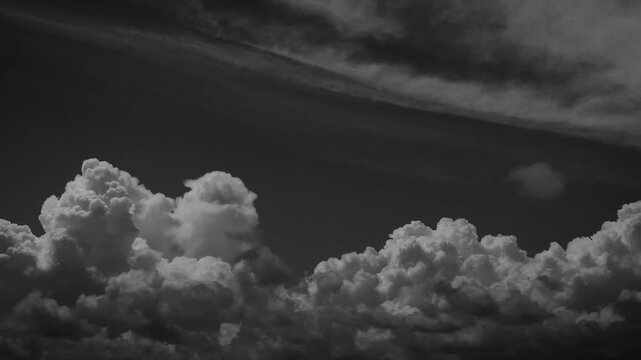 Dramatic time lapse of dark storm clouds rolling over a blue city sky during an overcast summer day