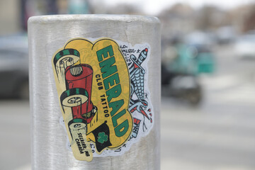 Naklejka premium close-up of street slaps for Emerald Club Tattoo located in Selkirk, Manitoba (Gordie Farrell) over another sticker in Toronto