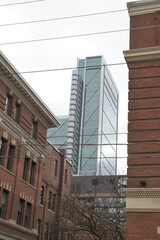 Obraz premium contrast of architectural styles... industrial brick buildings in the King-Spadina Heritage Conservation District and 8 Spadina Av designed by Hariri Pontarini Architects at The Well, Toronto
