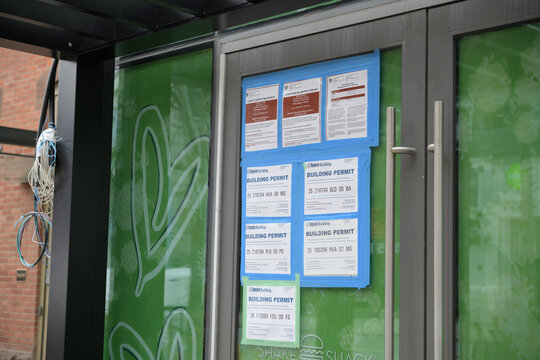 doors to a future location of Shake Shack (with building permits and public notice placards) outside 556 King St W (?), Toronto 