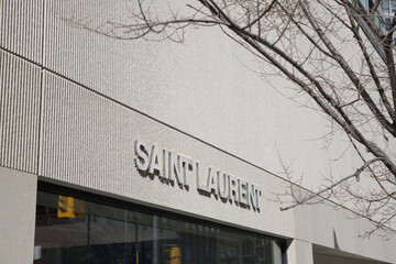 Naklejka premium exterior building facade and sign of Saint Laurent, a clothing store, located here at 110 Bloor St W, Toronto